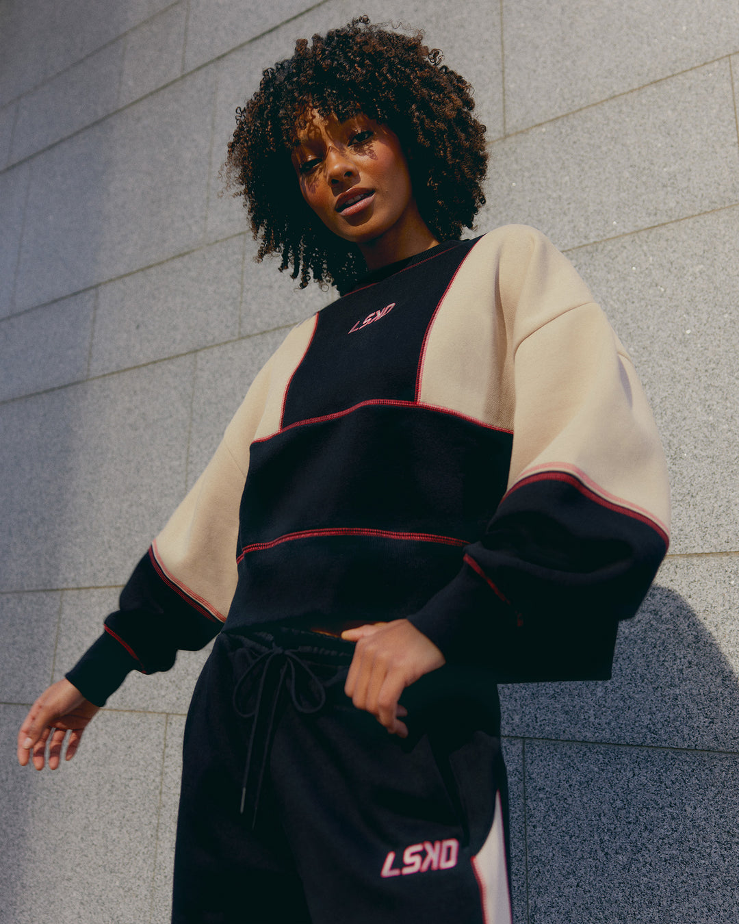 Woman wearing Stitch Up Oversized Fleece Sweater - Black-Shale Beige | Model:Tomi | Size:S