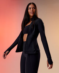 Woman wearing Stride Thermal Zip Through Jacket - Black | Model:Rhiley | Size:S