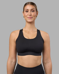 Woman wearing Stability Sports Bra - Black | Model:Amy | Size:S (D-E Cup)