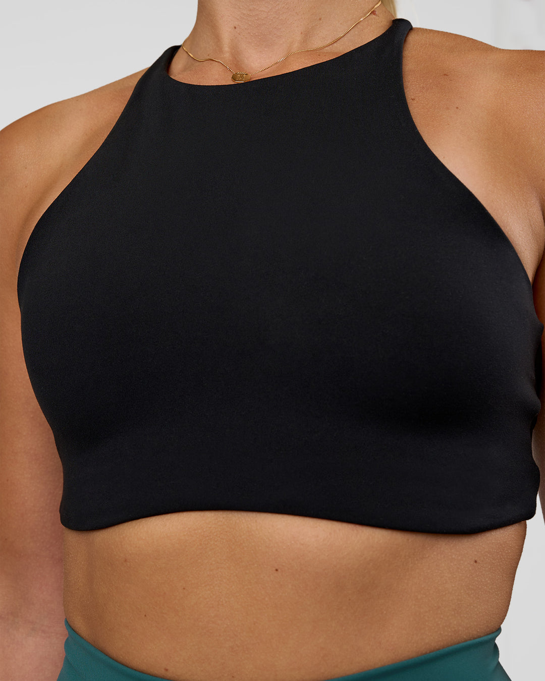 Woman wearing AMRAP High Neck Sports Bra - Black | Model:Myrte | Size:S