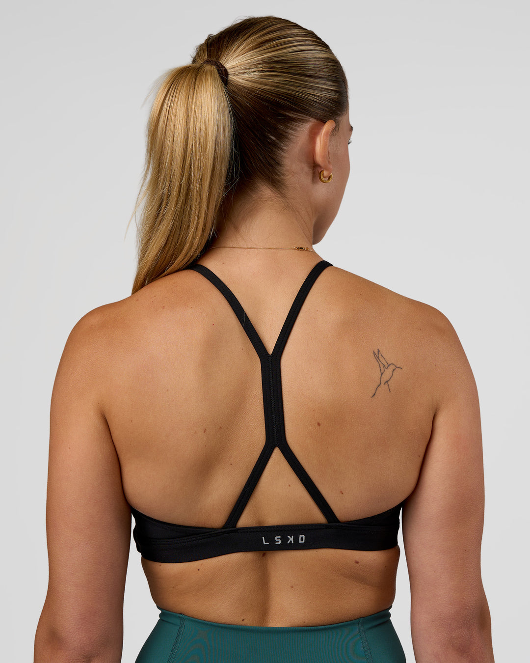 Woman wearing AMRAP High Neck Sports Bra - Black | Model:Myrte | Size:S