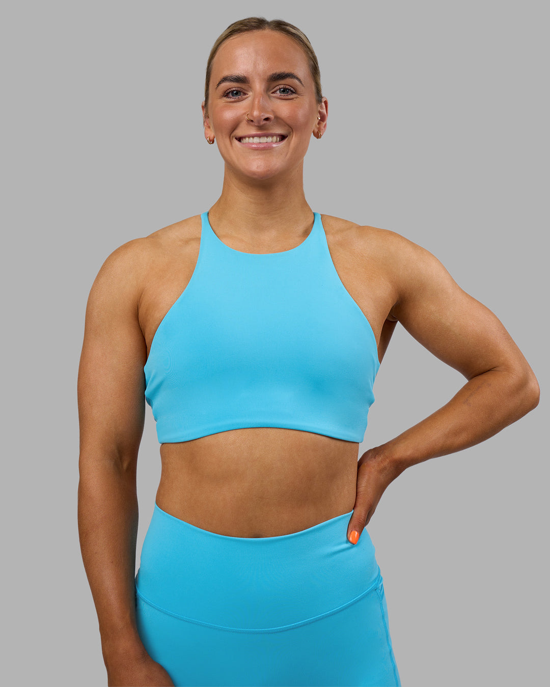 Woman wearing AMRAP High Neck Sports Bra - Blue Atoll | Model:Georgia | Size:S