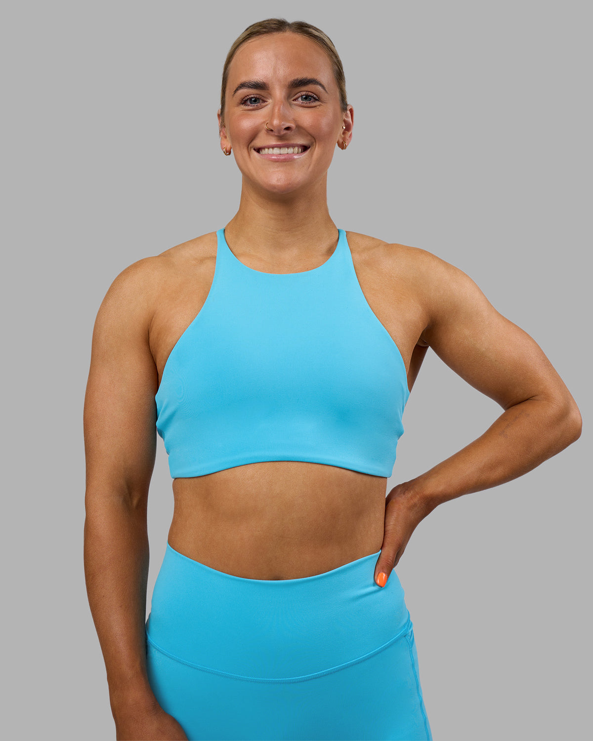 Woman wearing AMRAP High Neck Sports Bra - Blue Atoll | Model:Georgia | Size:S