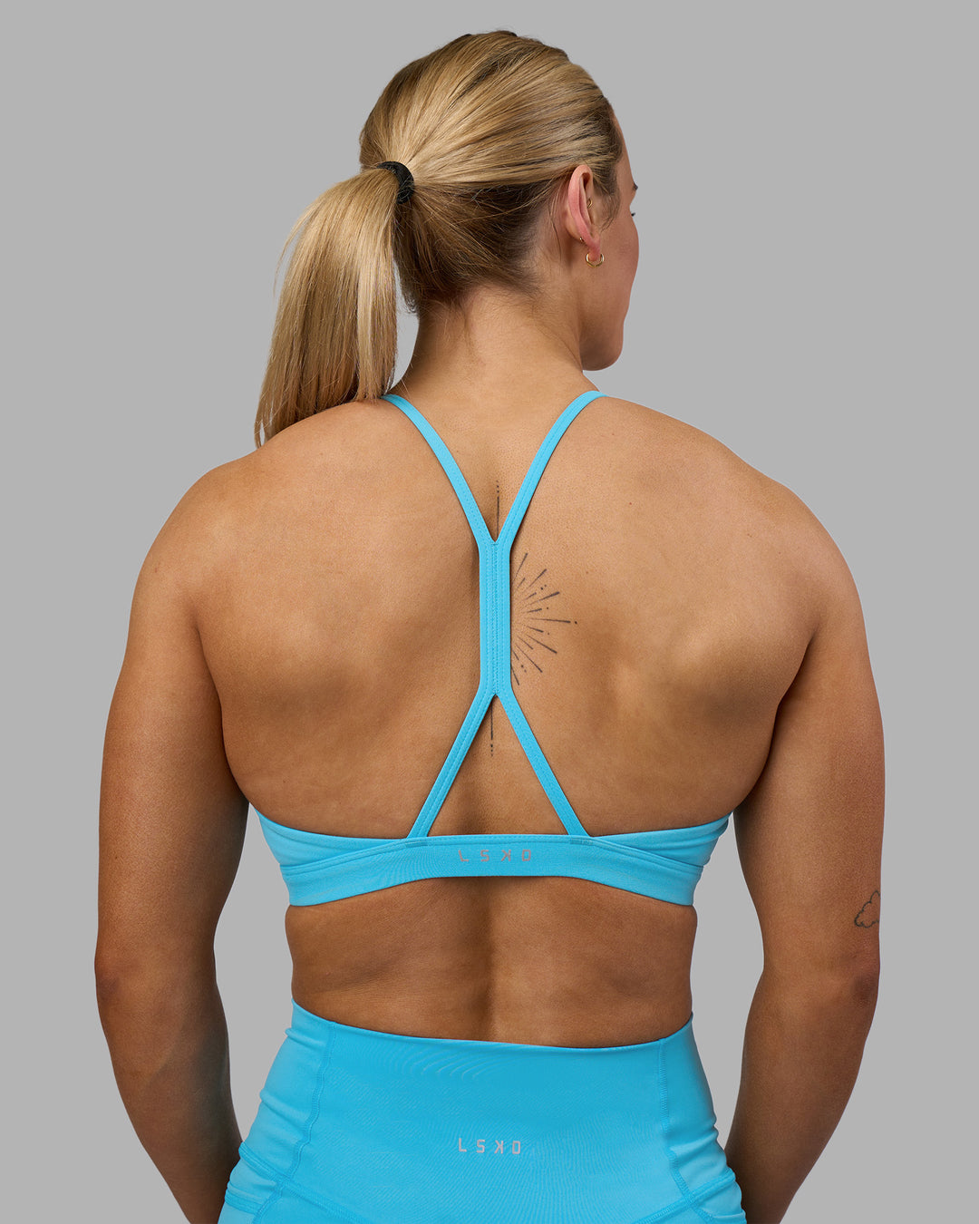 Woman wearing AMRAP High Neck Sports Bra - Blue Atoll | Model:Georgia | Size:S