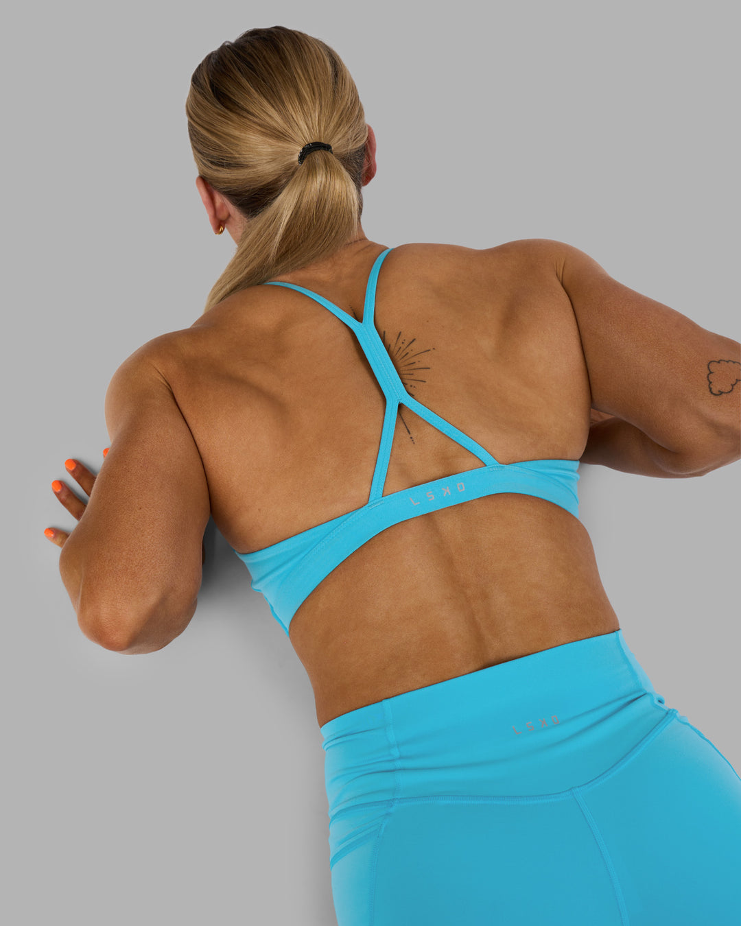 Woman wearing AMRAP High Neck Sports Bra - Blue Atoll | Model:Georgia | Size:S