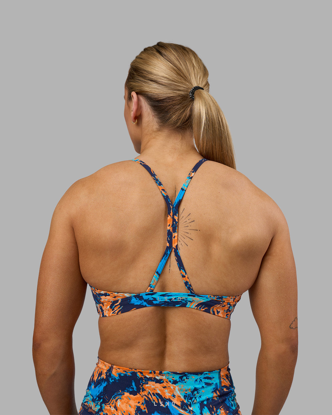 Woman wearing AMRAP High Neck Sports Bra - React Print | Model:Georgia | Size:S