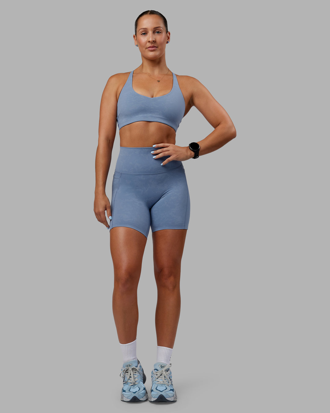 Woman wearing Abs Elixir Ultra High-Rise 6&quot; Short Pockets - Infinity Mirage