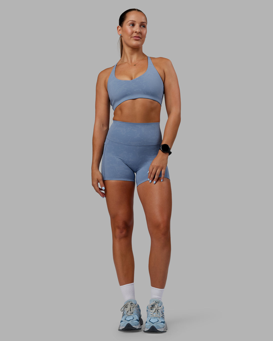 Woman wearing Abs Elixir Ultra High-Rise 4&quot; Short Pockets - Infinity Mirage
