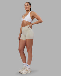 Woman wearing Abs Fusion High-Rise 4" Short Pockets - Shale Beige | Model:Abbey | Size:S