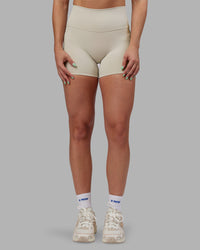 Woman wearing Abs Fusion High-Rise 4" Short Pockets - Shale Beige | Model:Abbey | Size:S