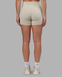 Woman wearing Abs Fusion High-Rise 4" Short Pockets - Shale Beige | Model:Abbey | Size:S