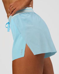Woman wearing Accelerate 3" High-Rise Running Short - Baltic Sea-Off White | Model:Emelia | Size:S