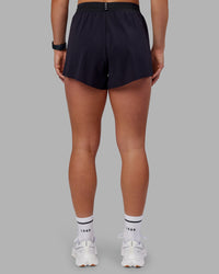 Woman wearing Accelerate 3" High-Rise Running Short - Black | Set:true | Angle:back | Model:Keisha | Size:S