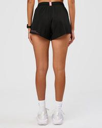 Woman wearing Accelerate 3" High-Rise Running Short - Black-Enjoy The Journey | Model:Rhiley | Size:S
