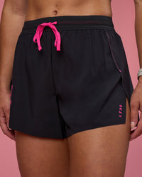 Woman wearing Accelerate 3" High-Rise Running Short - Black-Ultra Pink | Model:Hannah | Size:S