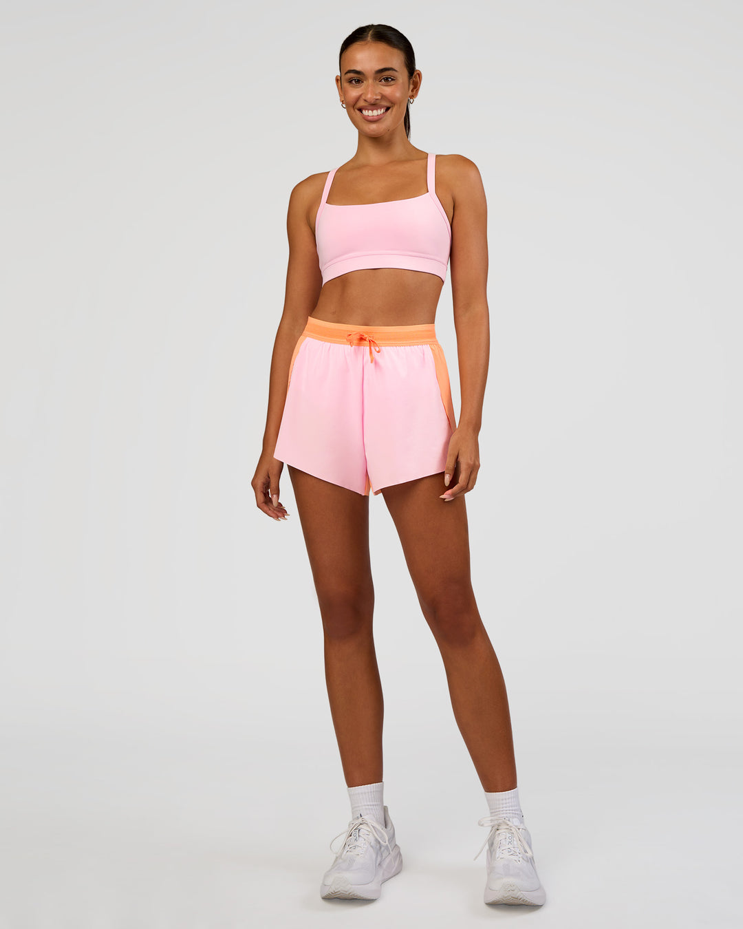Woman wearing Accelerate 3" High-Rise Running Short - Cantaloupe-Marshmallow | Model:Ruby | Size:S