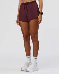 Woman wearing Accelerate 3" High-Rise Running Short - Cherry Lacquer | Model:Rhiley | Size:S