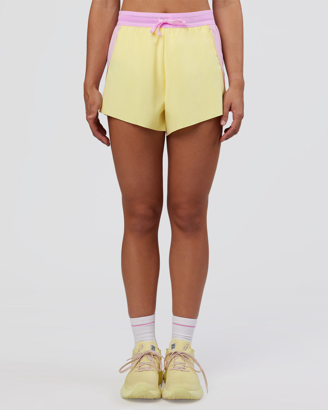 Woman wearing Accelerate 3" High-Rise Running Short - Marshmallow-Lemon | Set:true | Angle:front | Model:Grace | Size:S