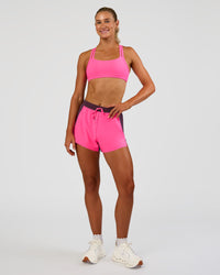 Woman wearing Accelerate 3" High-Rise Running Short - Midnight Plum-Sugar Plum | Model:Emelia | Size:S