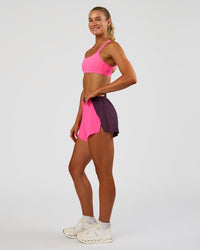 Woman wearing Accelerate 3" High-Rise Running Short - Midnight Plum-Sugar Plum | Model:Emelia | Size:S
