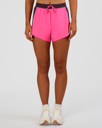 Woman wearing Accelerate 3" High-Rise Running Short - Midnight Plum-Sugar Plum | Set:true | Angle:front | Model:Emelia | Size:S