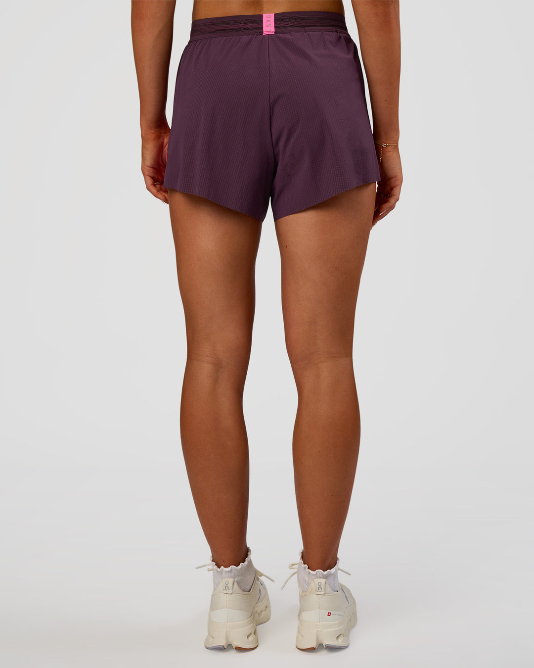 Woman wearing Accelerate 3" High-Rise Running Short - Midnight Plum-Sugar Plum | Set:true | Angle:back | Model:Emelia | Size:S
