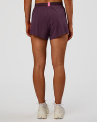 Woman wearing Accelerate 3" High-Rise Running Short - Midnight Plum-Sugar Plum | Set:true | Angle:back | Model:Emelia | Size:S