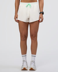 Woman wearing Accelerate 3" High-Rise Running Short - Off White-Floral Sticker | Set:true | Angle:front | Model:Abbey | Size:S