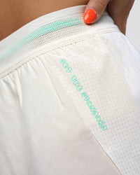 Woman wearing Accelerate 3" High-Rise Running Short - Off White-Floral Sticker | Model:Abbey | Size:S
