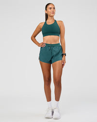 Woman wearing Accelerate 3" High-Rise Running Short - Transformative Teal | Model: Rhiley | Size:S