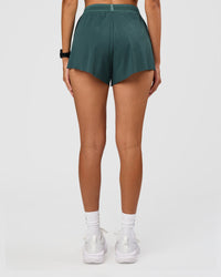 Woman wearing Accelerate 3" High-Rise Running Short - Transformative Teal | Set:true | Angle:back | Model: Rhiley | Size:S