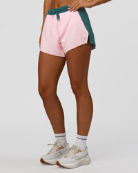 Woman wearing Accelerate 3" High-Rise Running Short - Transformative Teal-Marshmallow | Set:true | Angle:side | Model:Amity | Size:S