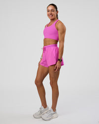Woman wearing Accelerate 3" High-Rise Running Short - Ultra Fuchsia | Model:Zara | Size:S