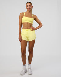 Woman wearing Accelerate 3" High-Rise Running Short - Yellow Fizz | Model:Evie | Size:S