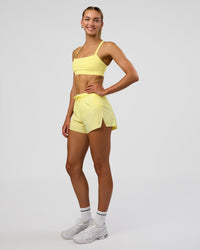 Woman wearing Accelerate 3" High-Rise Running Short - Yellow Fizz | Model:Evie | Size:S