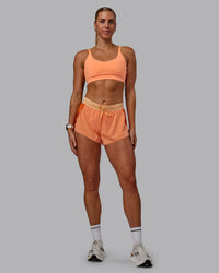 Woman wearing Accelerate 3" Run Shorts - Cantaloupe Colourblock