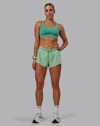 Woman wearing Accelerate 3" Run Shorts - Surreal Green