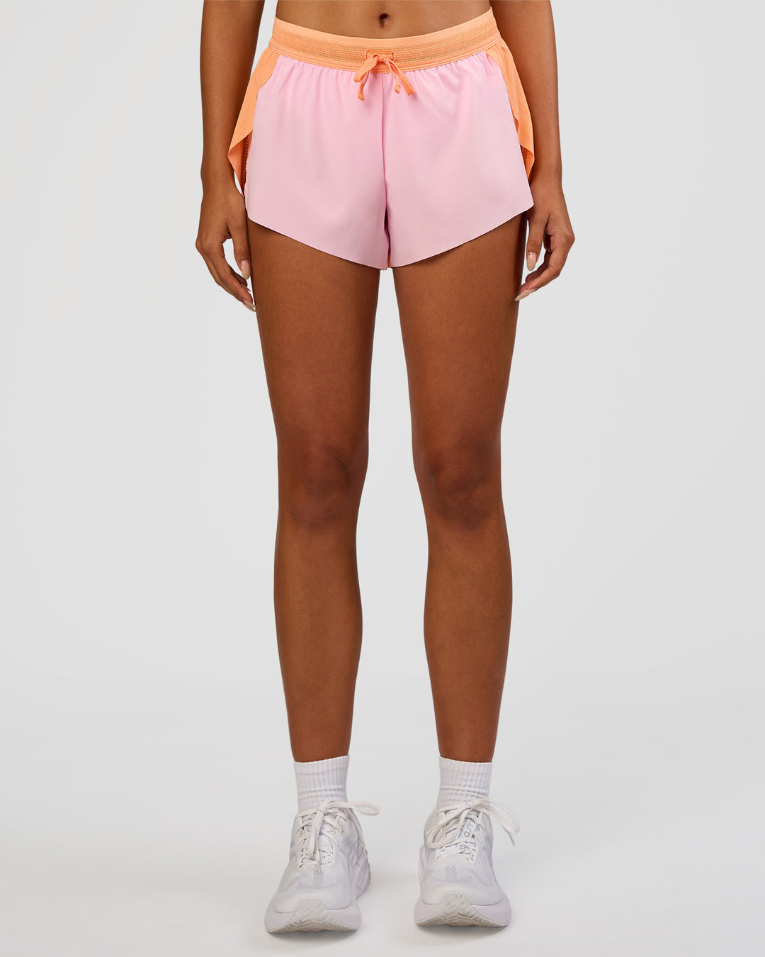 Woman wearing Accelerate 3" Mid-Rise Running Short - Cantaloupe-Marshmallow | Model:Ruby | Size:S