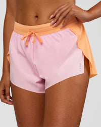 Woman wearing Accelerate 3" Mid-Rise Running Short - Cantaloupe-Marshmallow | Set:true | Angle:closeup | Model:Ruby | Size:S