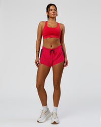 Woman wearing Accelerate 3" Mid-Rise Running Short - Cherry Lacquer-Scarlet | Model:Bianca | Size:S |