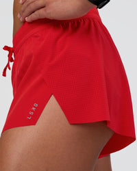 Woman wearing Accelerate 3" Mid-Rise Running Short - Flame | Model:Sav | Size:S