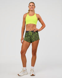 Woman wearing Accelerate 3" Mid-Rise Running Short - Friction Print Hyper Green | Model:Emelia | Size:S