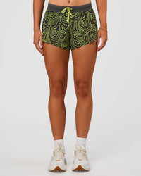 Woman wearing Accelerate 3" Mid-Rise Running Short - Friction Print Hyper Green | Set:true | Angle:front | Model:Emelia | Size:S