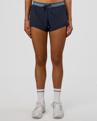 Woman wearing Accelerate 3" Mid-Rise Running Short - Future Navy-Baltic Sea | Set:true | Angle:front | Model:Evie | Size:S