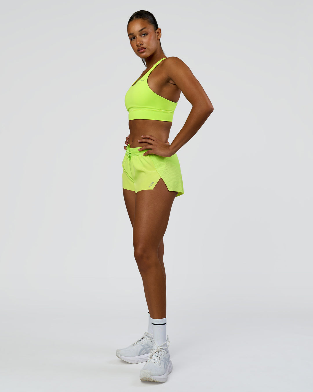 Woman wearing Accelerate 3" Mid-Rise Running Short - Hyper Green | Model:Rosie | Size:S