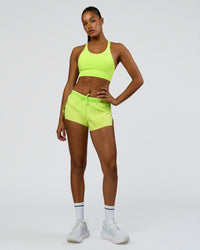 Woman wearing Accelerate 3" Mid-Rise Running Short - Hyper Green | Model:Rosie | Size:S