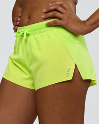 Woman wearing Accelerate 3" Mid-Rise Running Short - Hyper Green | Set:true | Angle:closeup | Model:Rosie | Size:S