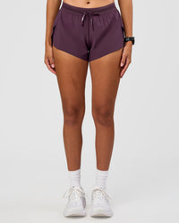 Woman wearing Accelerate 3" Mid-Rise Running Short - Midnight Plum | Set:true | Angle:front | Model:Rhiley | Size:S