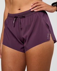 Woman wearing Accelerate 3" Mid-Rise Running Short - Midnight Plum | Set:True | Angle:closeup | Model:Rhiley | Size:S