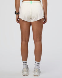 Woman wearing Accelerate 3" Mid-Rise Running Short - Off White-Floral Sticker | Set:true | Angle:back | Model:Abbey | Size:S
